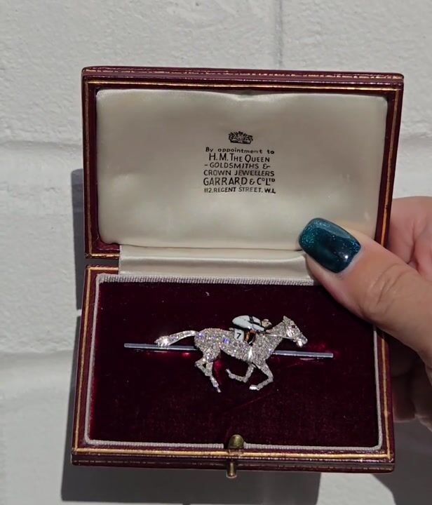 Film of A Magnificent Mid-20th Century Circa 1940 Platinum-topped 18ct Gold Diamond, Enamel, and Ruby Equestrian Racing Brooch, Retailed by Garrard & Co.