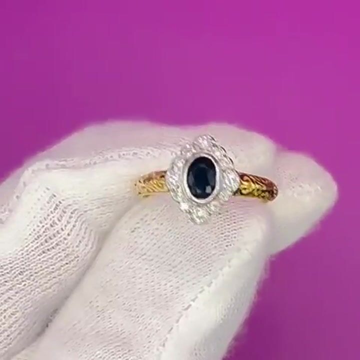Film of 18ct Gold Oval Cut Sapphire and Diamond (0.16ct) Cluster Ring