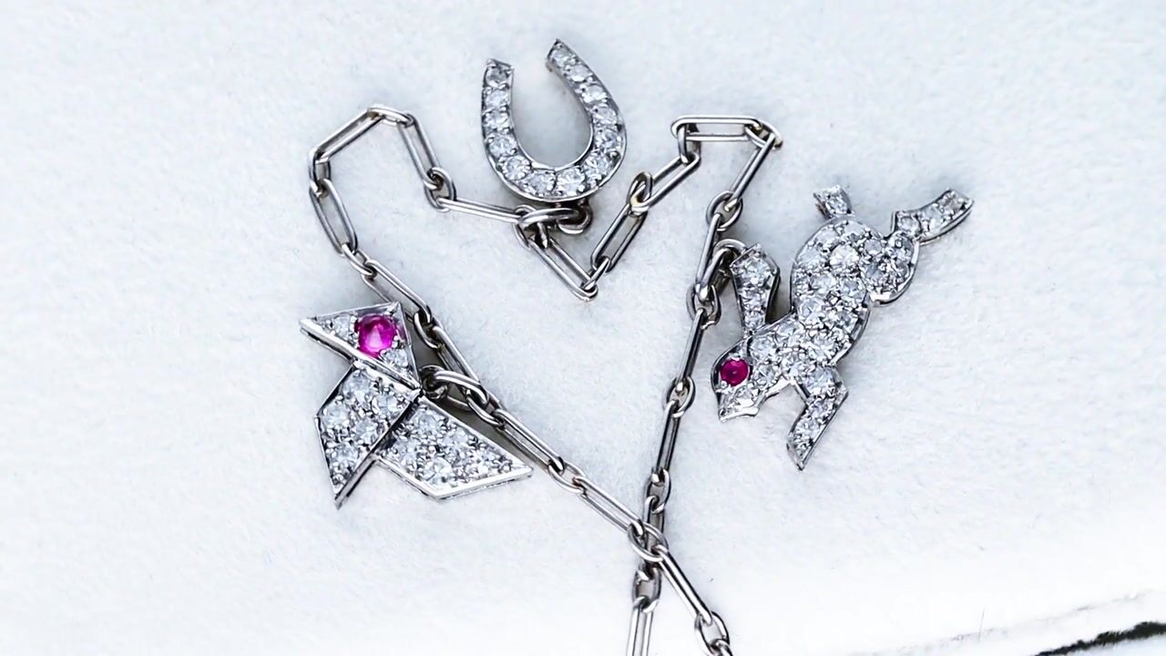 Film of Antique Ruby and 0.85ct Diamond Platinum Charm Bracelet Circa 1915