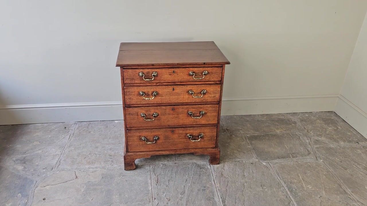 Film of A Very Small Georgian Oak Chest of Drawers.